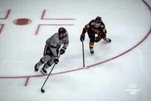 UNO Mavericks player, Sam Stange, looks for an open man during a college hockey game on Jan 11th, 2025 in Omaha, Nebraska. Photo by Logan Hock