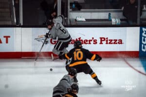 UNO Mavericks player, Zach Urdahl, handles the puck during a college hockey game on Jan 11th, 2025 in Omaha, Nebraska. Photo by Logan Hock