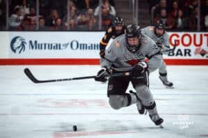 UNO Mavericks player, Sam Stange, handles the puck during a college hockey game on Jan 11th, 2025 in Omaha, Nebraska. Photo by Logan Hock