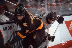 UNO Mavericks player, Brock Bremer, fights for the puck during a college hockey game on Jan 11th, 2025 in Omaha, Nebraska. Photo by Logan Hock