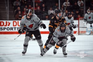 UNO Mavericks players, Harrison Israels and Brock Bremer, rush toward the goal during a college hockey game on Jan 11th, 2025 in Omaha, Nebraska. Photo by Logan Hock