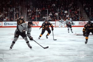 UNO Mavericks player, Tyler Rollwagen, handles the puck during a college hockey game on Jan 11th, 2025 in Omaha, Nebraska. Photo by Logan Hock.