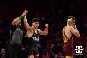 #5 Nebraska Cornhusker Ridge Lovett celebrates the win against #21 Minnesota Golden Gopher Drew Roberts during a college wrestling match, Saturday, January 11, 2025, in Lincoln, Nebraska. Lovett defeats Roberts 5-0. Photo by John S. Peterson.