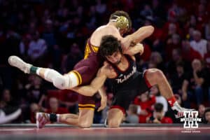#5 Nebraska Cornhusker Ridge Lovett shoots for the leg against #21 Minnesota Golden Gopher Drew Roberts during a college wrestling match, Saturday, January 11, 2025, in Lincoln, Nebraska. Lovett defeats Roberts 5-0. Photo by John S. Peterson.