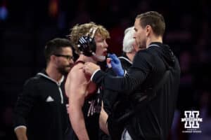 #19 Nebraska Cornhusker Jacob Van Dee gets a bloody lip cleaned up against #11 Minnesota Golden Gophers Tyler Wells during a college wrestling match, Saturday, January 11, 2025, in Lincoln, Nebraska. Van Dee upsets Wells 4-1. Photo by John S. Peterson.