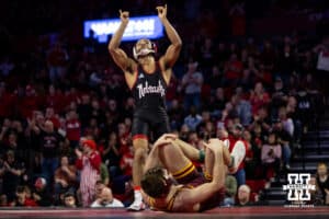 #7 Nebraska Cornhusker Caleb Smith celebrates the upset against #5 Minnesota Golden Gopher Cooper Flynn during a college wrestling match, Saturday, January 11, 2025, in Lincoln, Nebraska. Smith upsets Flynn 2-0. Photo by John S. Peterson.