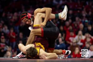 #7 Nebraska Cornhusker Caleb Smith wrestles against #5 Minnesota Golden Gopher Cooper Flynn during a college wrestling match, Saturday, January 11, 2025, in Lincoln, Nebraska. Smith upsets Flynn 2-0. Photo by John S. Peterson.