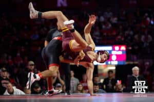 #7 Nebraska Cornhusker Caleb Smith throws #5 Minnesota Golden Gopher Cooper Flynn during a college wrestling match, Saturday, January 11, 2025, in Lincoln, Nebraska. Smith upsets Flynn 2-0. Photo by John S. Peterson.