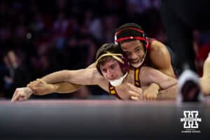 #7 Nebraska Cornhusker Caleb Smith works to control the arms against #5 Minnesota Golden Gopher Cooper Flynn during a college wrestling match, Saturday, January 11, 2025, in Lincoln, Nebraska. Smith upsets Flynn 2-0. Photo by John S. Peterson.