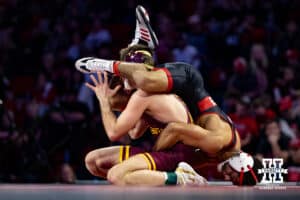 #7 Nebraska Cornhusker Caleb Smith wrestles #5 Minnesota Golden Gopher Cooper Flynn during a college wrestling match, Saturday, January 11, 2025, in Lincoln, Nebraska. Smith upsets Flynn 2-0. Photo by John S. Peterson.