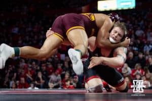 #22 Nebraska Cornhusker Camden McDanel shoots for a leg against #9 Minnesota Golden Gopher Isaiah Salazar during a college wrestling match, Saturday, January 11, 2025, in Lincoln, Nebraska. Salazar defeats McDanel 8-0. Photo by John S. Peterson.