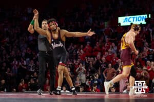 Nebraska Cornhusker Christopher Minto celebrates the win against #9 Minnesota Golden Gopher Andrew Sparks during a college wrestling match, Saturday, January 11, 2025, in Lincoln, Nebraska. Minto upsets Sparks 5-4. Photo by John S. Peterson.