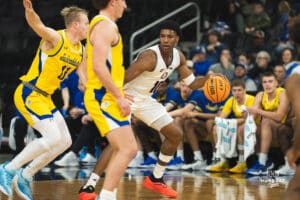Omaha Maverick Marquel Sutton takes on two defenders during a basketball game at Baxter Arena on January 11th, 2025 in Omaha Nebraska. Photo by Collin Stilen.