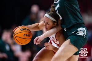 Nebraska Cornhuskers guard Callin Hake (14) drives into Michigan State Spartans guard Emma Shumate (5) bringing the ball down the court in the second half during a college basketball game, Wednesday, January 8, 2025, in Lincoln, Nebraska. Photo by John S. Peterson.