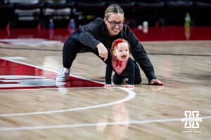 Baby and mom having fun at the halftime baby races during women’s college basketball game against the Penn State Nittany Lions, Sunday, January 5, 2025, in Lincoln, Nebraska. Photo by John S. Peterson.