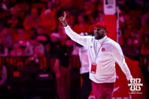 Former player Erick Strickland waves to the fans as he walks out on the court at halftime during college basketball game against the UCLA Bruins, Saturday, January 4, 2024, in Lincoln, Nebraska. Photo by John S. Peterson.