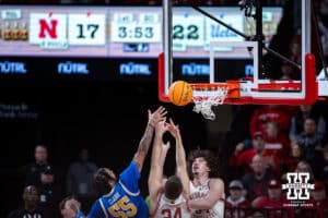 UCLA Bruins guard Skyy Clark (55), reaches for a rebound against Nebraska Cornhuskers guard Rollie Worster (24) and center Braxton Meah (34) in the first half during college basketball game, Saturday, January 4, 2024, in Lincoln, Nebraska. Photo by John S. Peterson.