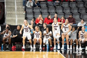 Omaha Mavericks bench celebrates during a college basketball game against North Dakota on January 2nd, 2025 in Omaha Nebraska. Photo by Brandon Tiedemann.