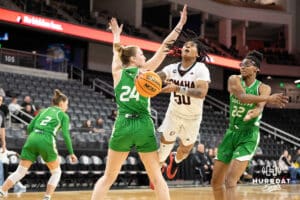 Omaha Mavericks Ja Harvey slips past defenders and attempts a layup during a college basketball game against North Dakota on January 2nd, 2025 in Omaha Nebraska. Photo by Brandon Tiedemann.