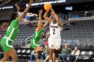 Omaha Mavericks Lauren Perry looks to pass through defenders during a college basketball game against North Dakota on January 2nd, 2025 in Omaha Nebraska. Photo by Brandon Tiedemann.