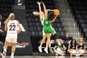 Omaha Maverick Grace Cave contesting a shot during a college basketball game against North Dakota on January 2nd, 2025 in Omaha Nebraska. Photo by Brandon Tiedemann.