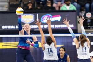 Omaha Supernovas Emily Londot (27) spikes the ball against Orlando Valkyries Adora Anae (14) and Natalie Foster (13) during professional volleyball event Thursday, February 27, 2025 in Lincoln, Nebraska. Photo by John S. Peterson.