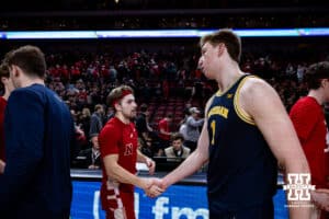 Nebraska Cornhusker guard Sam Hoiberg (1) shakes hands with Michigan Wolverine center Danny Wolf (1) after the college men’s basketball game Monday, February 24, 2025 in Lincoln, Nebraska. Photo by John S. Peterson.