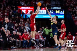 Nebraska Cornhusker guard Sam Hoiberg (1) makes a three-point shot against Michigan Wolverine forward Will Tschetter (42) in the second half during a college men’s basketball game Monday, February 24, 2025 in Lincoln, Nebraska. Photo by John S. Peterson.