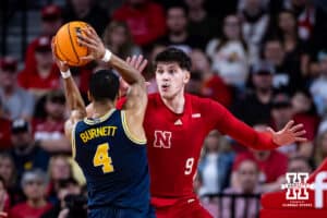 Nebraska Cornhusker forward Berke Buyuktuncel (9) defends against Michigan Wolverine guard Nimari Burnett (4) in the first half during a college men’s basketball game Monday, February 24, 2025 in Lincoln, Nebraska. Photo by John S. Peterson.