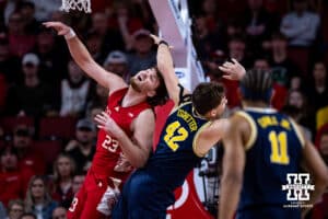 Nebraska Cornhusker forward Andrew Morgan (23) gets hit by Michigan Wolverine forward Will Tschetter (42) going after the ball in the first half during a college men’s basketball game Monday, February 24, 2025 in Lincoln, Nebraska. Photo by John S. Peterson.