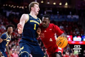 Nebraska Cornhusker forward Juwan Gary (4) dribbles the ball against Michigan Wolverine center Danny Wolf (1) in the first half during a college men’s basketball game Monday, February 24, 2025 in Lincoln, Nebraska. Photo by John S. Peterson.