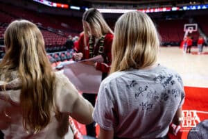 A Nebraska Cornhusker fan collects Husker autographs on her t-shirt as Allison Weidner sign an autograph after a college women’s basketball game against the Washington Huskies Sunday, February 23, 2025 in Lincoln, Nebraska. Photo by John S. Peterson.
