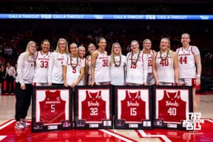 The four Nebraska seniors, Alberte Rimdal (5), Kendall Coley(32), Kendall Moriarty (15), and Alexis Markowski (40) pose with their teammate for a photo during the Senior Day celebration after a college women’s basketball game against the Washington Huskies Sunday, February 23, 2025 in Lincoln, Nebraska. Photo by John S. Peterson.