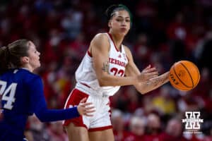 Nebraska Cornhusker forward Kendall Coley (32) makes a pass against Washington Huskies guard Elle Ladine (24) in the first half during a college women’s basketball game Sunday, February 23, 2025 in Lincoln, Nebraska. Photo by John S. Peterson.