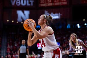 Nebraska Cornhusker guard Callin Hake (14) makes a three-point shot against the Washington Huskiess in the first quarter during a college women’s basketball game Sunday, February 23, 2025 in Lincoln, Nebraska. Photo by John S. Peterson.