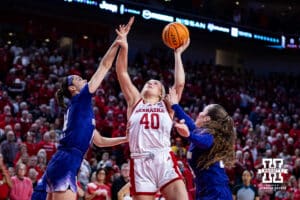 Nebraska Cornhusker center Alexis Markowski (40) makes a layup against Washington Huskies forward Dalayah Daniels (14) and guard Elle Ladine (24) in the first quarter during a college women’s basketball game Sunday, February 23, 2025 in Lincoln, Nebraska. Photo by John S. Peterson.