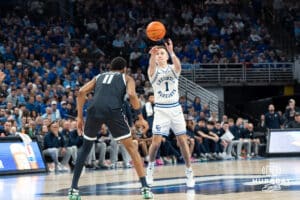 Creighton Bluejays Steven Ashworth looks to throw a lob pass during a college basketball game against Georgetown on February 23rd, 2025 in Omaha Nebraska. Photo by Brandon Tiedemann.