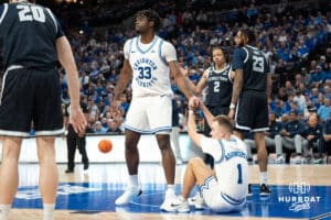 Creighton Bluejays Fredrick King helps teammate Steven Ashworth up after a foul during a college basketball game against Georgetown on February 23rd, 2025 in Omaha Nebraska. Photo by Brandon Tiedemann.