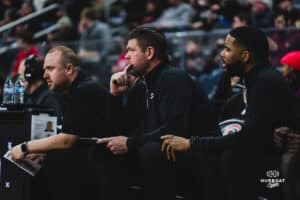 Omaha Maverick coaches Brandt Danals, Kyan Brown and Warren Niles watch from the sideline during a basketball game at Baxter Arena on February 22nd, 2025 in Omaha Nebraska. Photo by Collin Stilen.
