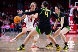 Nebraska Cornhusker guard Callin Hake (14) dribbles the ball against Oregon Duck guard Nani Falatea (4) and guard Elisa Mevius (8) in the third quarter during a college women’s basketball game Wednesday, February 19, 2025 in Lincoln, Nebraska. Photo by John S. Peterson.