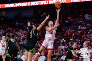 Nebraska Cornhusker forward Jessica Petrie (12) makes a layup against Oregon Duck guard Sofia Bell (3) in the third quarter during a college women’s basketball game Wednesday, February 19, 2025 in Lincoln, Nebraska. Photo by John S. Peterson.