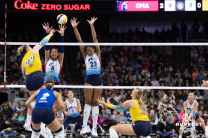 Omaha Supernovas Reagan Cooper (8) and Kaitlyn Hord (23) jump to defend against San Diego Mojo Kayla Lund (28) in the third set during a professional volleyball match Sunday, February 16, 2025 in Omaha, Nebraska. Photo by John S. Peterson.