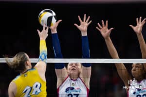 Omaha Supernovas Emily Londot (27) jumps up with Kaitlyn Hord (23) to block a spike from San Diego Mojo Kayla Lund (28) during a professional volleyball match Sunday, February 16, 2025 in Omaha, Nebraska. Photo by John S. Peterson.