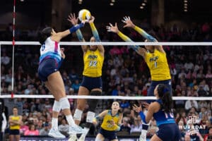 Omaha Supernovas Reagan Cooper (8) spikes the ball against San Diego Mojo Lauren Page (32) and Rainelle Jones (1) in the first set during a professional volleyball match Sunday, February 16, 2025 in Omaha, Nebraska. Photo by John S. Peterson.