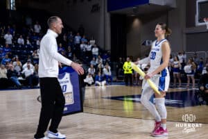 Creighton Bluejay head coach Jim Flanery gives senior Morgan Maly a hug on Senior Day after the win against the Georgetown Hoyas during a college basketball game Saturday, February 15, 2025 in Omaha, Nebraska. Photo by John S. Peterson.