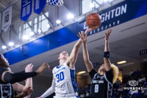 Creighton Bluejay guard Morgan Maly (30) reaches for the rebound against Georgetown Hoya guard Khadee Hession (8) in the fourth quarter during a college basketball game Saturday, February 15, 2025 in Omaha, Nebraska. Photo by John S. Peterson.