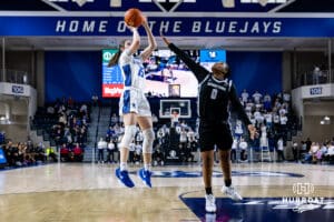 Creighton Bluejay guard Lauren Jensen (15) makes a jump shot against Georgetown Hoya guard Jaeda Wilson (0) in the third quarter during a college basketball game Saturday, February 15, 2025 in Omaha, Nebraska. Photo by John S. Peterson.