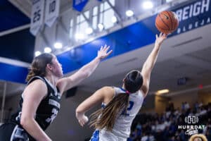 Creighton Bluejay guard Kennedy Townsend (2) makes a lay up agianst Georgetown Hoya guard Siobhan Ryan (32) in the third quarter during a college basketball game Saturday, February 15, 2025 in Omaha, Nebraska. Photo by John S. Peterson.