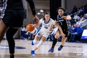 Creighton Bluejay guard Lauren Jensen (15) drives the lane against Georgetown Hoya guard Kelsey Ransom (1) in the third quarter during a college basketball game Saturday, February 15, 2025 in Omaha, Nebraska. Photo by John S. Peterson.
