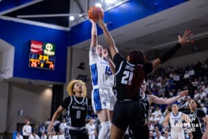 Creighton Bluejay guard Lauren Jensen (15) makes a lay up against Georgetown Hoya center Ariel Jenkins (21) in the second quarter during a college basketball game Saturday, February 15, 2025 in Omaha, Nebraska. Photo by John S. Peterson.